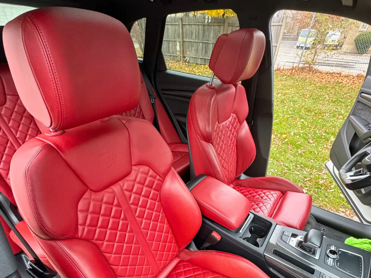 Red leather Audi seats cleaned and conditioned during a mobile detail in Cleveland